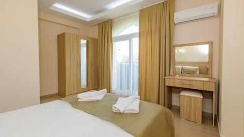 a bedroom with a large bed and a mirror at Musa - 5 Bedroom Holiday Villa in Hisaronu in Fethiye