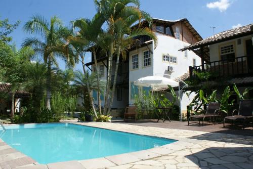 a swimming pool in front of a house at Atobá Villas in Paraty