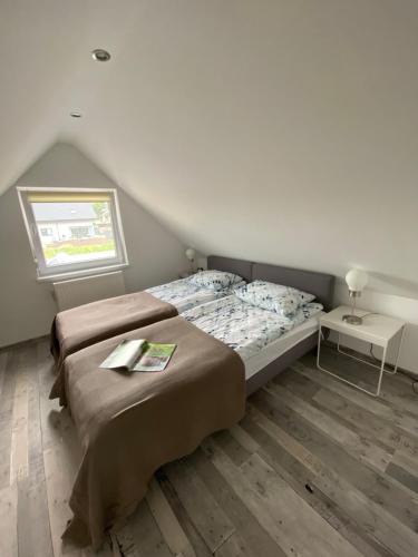 a bedroom with two beds and a window at Dom z sauną na wyłączność in Drawno