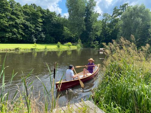 two people in a boat on a river at Landhaus Viezer Mühle in Viez