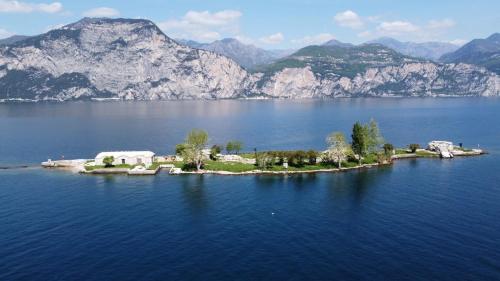 an island in the middle of a large body of water at Albergo Casa Este in Brenzone sul Garda