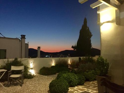 a garden at night with a tree in the distance at Romantica Suites in Naousa