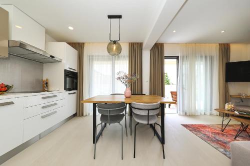 a kitchen and dining room with a table and chairs at Luxury Aparthotel Zadar in Zadar