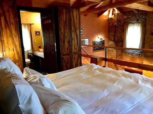 a bedroom with a white bed in a room at Montanema Handmade Village in Platanákos