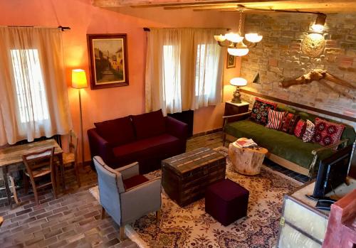 a living room with a couch and a chair at Montanema Handmade Village in Platanákos