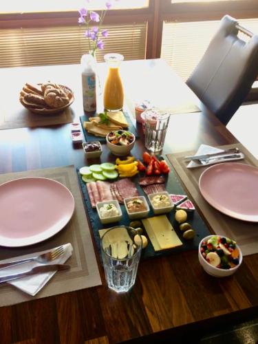 a table with plates and food on top of it at Grand Spa Holiday Home in Sklené Teplice
