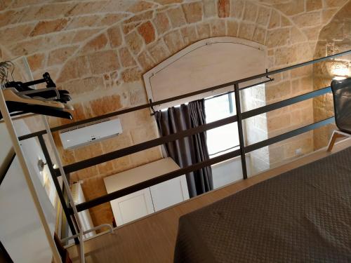 a room with a window in a brick wall at Monolocale prezioso in Trani
