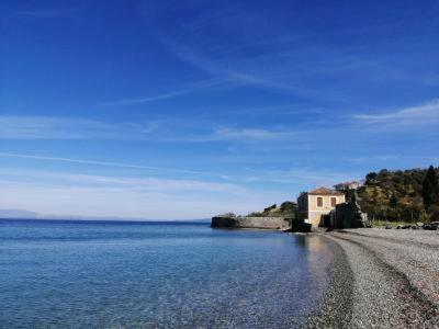a beach with a large body of water at Manoleas Rooms to Let in Leonidion