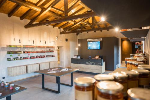 a shop with a table and stools in a room at Santoro Country House in Castiglione di Sicilia