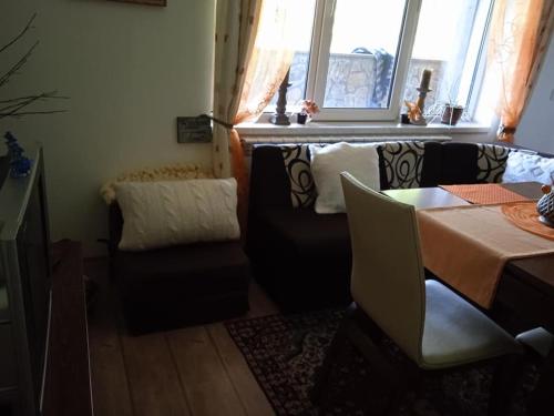 a living room with a table and a couch at Спа,ски апартамент Дайли, Стрийм Ризорт Пампорово in Pamporovo