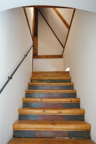 a set of stairs in a house with wooden ceilings at Baroque chaplain house Kaplanka 1796 A. D. - historical luxury apts in Bohemian Paradise in Železný Brod
