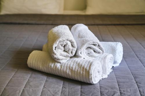 a stack of towels on the floor in a bathroom at M9 Rooms in Izola