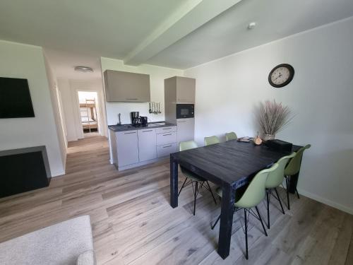 a kitchen and dining room with a table and chairs at Appartement Rakké Kiefernweg Winterberg in Winterberg