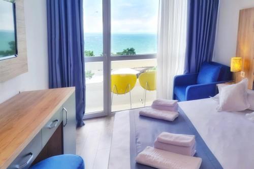 a hotel room with a bedroom with a view of the ocean at Hotel Opal in Jupiter