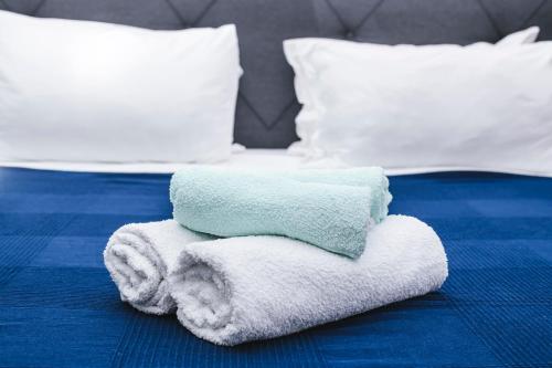 a pile of towels sitting on top of a bed at M9 Rooms in Izola