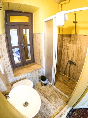 a bathroom with a shower and a toilet and a sink at Adatepe Otel in Adatepe