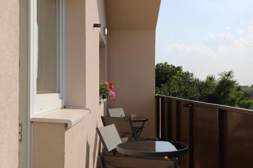 a balcony with a table and chairs on a balcony at Rezidencia Podhájska in Podhájska