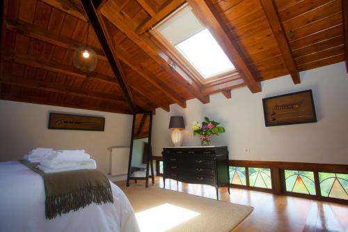 a bedroom with a bed and a wooden ceiling at Casona de Indias in Piloña