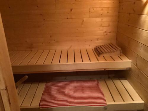a wooden sauna with a bed in it at Chalet Les Sorbiers in Égat