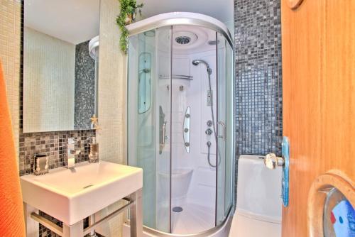 a bathroom with a sink and a shower at Marina-M in Lagos
