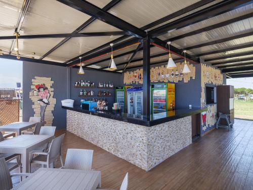 a restaurant with a bar with tables and chairs at Elysium Green Suites in Antalya