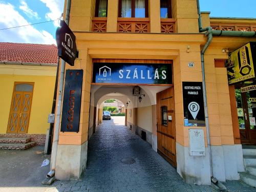 an entrance to a building with a sign on it at Nádasdi Ház in Szekszárd