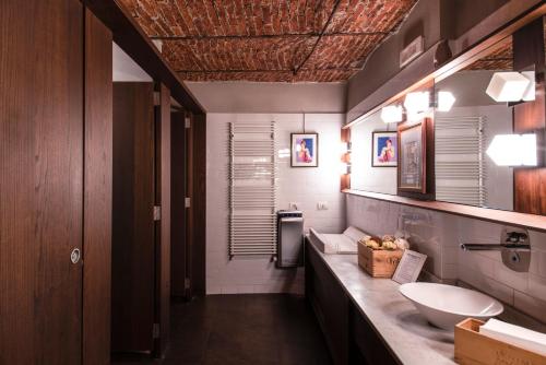 a bathroom with a sink and a toilet in it at Hotel Osteria della Pista dal 1875 in Casorate Sempione