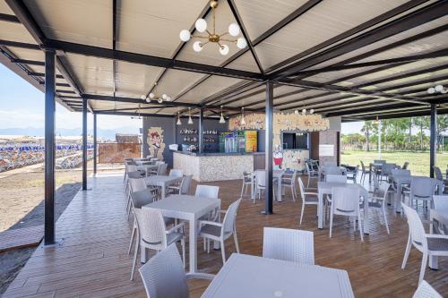 a restaurant with tables and chairs and a bar at Elysium Green Suites in Antalya