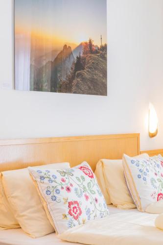 a bed with two pillows on top of it at Hotel garni Weberhäusl in Strobl