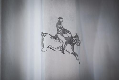 a drawing of a man riding a horse at Hotel Osteria della Pista dal 1875 in Casorate Sempione