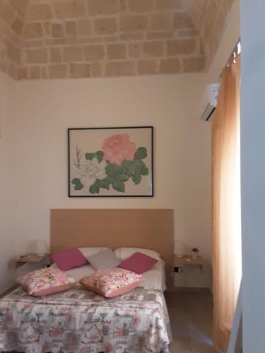 a bedroom with a bed with two pillows on it at B&B Emily Brindisi in Brindisi
