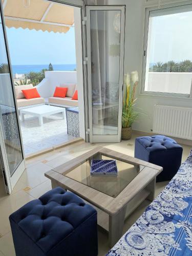 a living room with a coffee table and a couch at Roof Top Pied dans l'Eau Panoramic View, 80 meters from Seaside in Hammamet