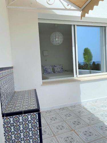 a room with a bench and a window with a view at Roof Top Pied dans l'Eau Panoramic View, 80 meters from Seaside in Hammamet