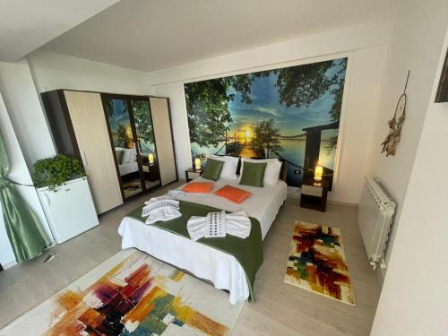 a bedroom with two beds and a large window at DreamView Mamaia SummerApt in Mamaia