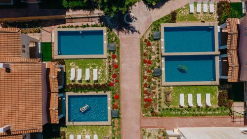 eine Aussicht über zwei Swimmingpools in einer Stadt in der Unterkunft Corinthian Village in Vrachati