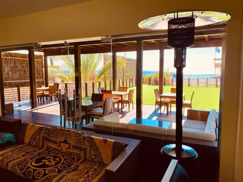 a living room with a couch and tables and chairs at The Wind Farm in Dahab
