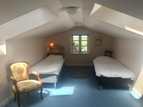 En eller flere senge i et værelse på Vita og Pouls Gård - Guesthouse