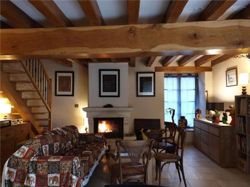 a living room with a couch and a fireplace at La Tour du Raygnier in Verneuil-le-Château