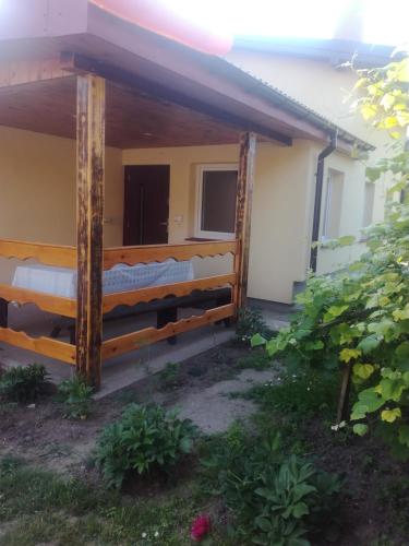 a house with a wooden fence in front of it at Zaciszny Zakątek in Drohiczyn nad Bugiem