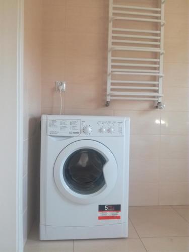 a washer and dryer in a corner of a room at Zaciszny Zakątek in Drohiczyn nad Bugiem