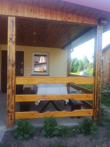 a wooden pavilion with a bed in a yard at Zaciszny Zakątek in Drohiczyn nad Bugiem