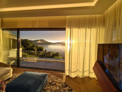 a living room with a large window with a view at Suiten-Aparthotel AENEA in Reifnitz