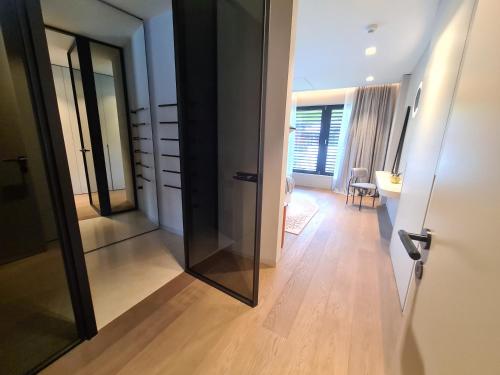 a hallway with a large mirror and a room at Suiten-Aparthotel AENEA in Reifnitz