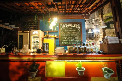 a bar with a sign on the wall of a restaurant at Pousada Bartholomeu in Paraty
