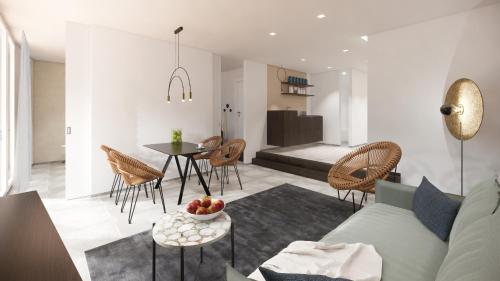 a living room with a couch and a table and chairs at Suiten-Aparthotel AENEA in Reifnitz