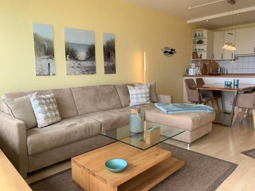 a living room with a couch and a table at Haus Fischerstrand - Fewo Boje in Dahme