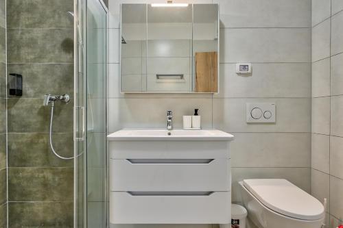 a bathroom with a sink and a toilet and a shower at Pure in Medulin