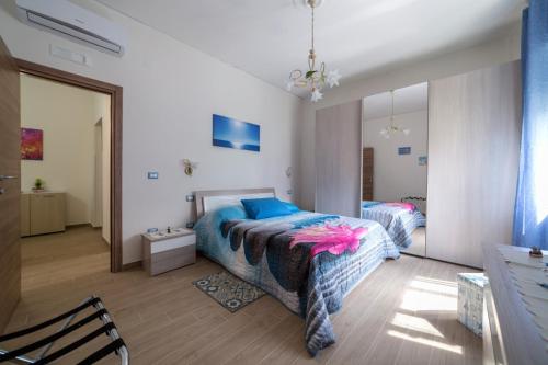 a bedroom with two beds and a mirror at Osolemiohouse in Minori