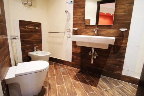 a bathroom with a toilet and a sink at Nuraghe Apartments in Teulada