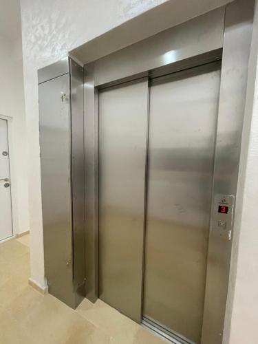 a large metal elevator in a building at Seaside Apartments Sword in Bar